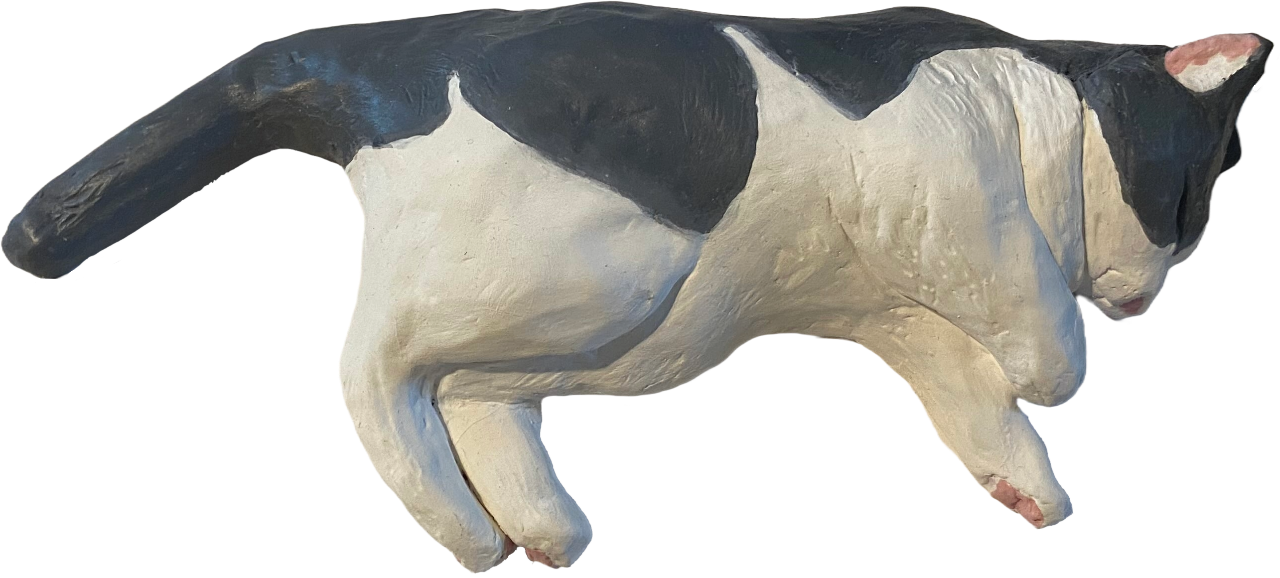 Ceramic sculpture of a grey and white cat laying down with its eyes closed, seen from above